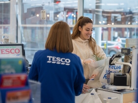 Young Tesco shopper collecting their Clubcard points