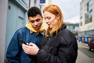 Two friends looking at phone